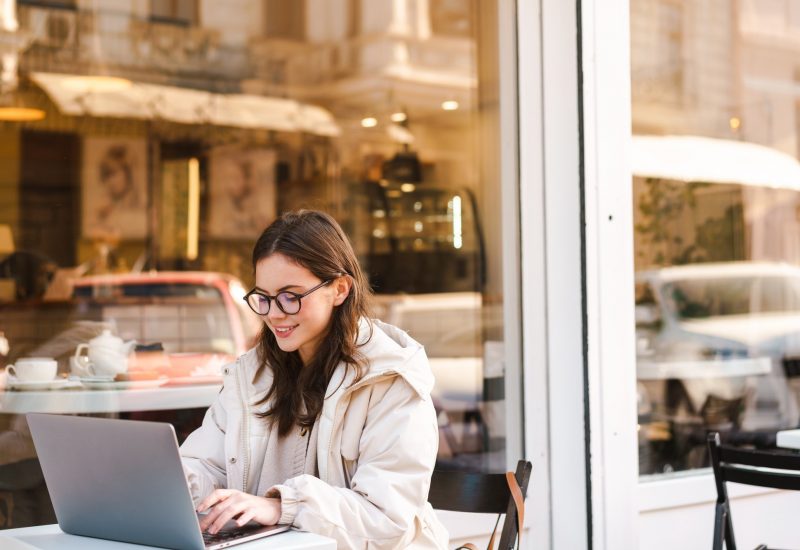 Smiling young woman using laptop